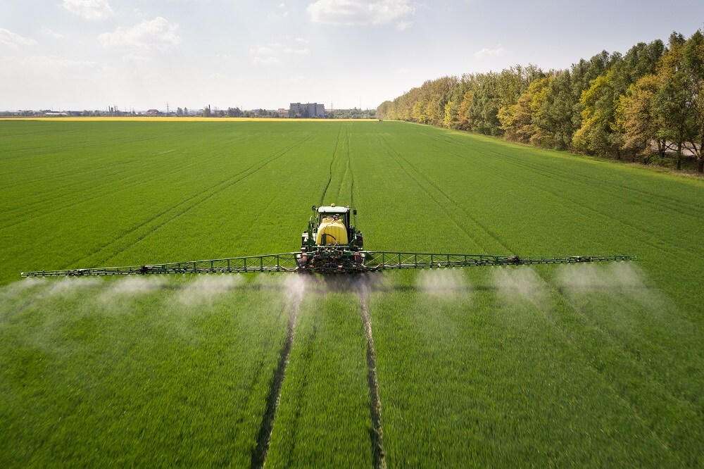 tractor-spraying-pesticides-with-sprayer-large-green-agricultural-field-1